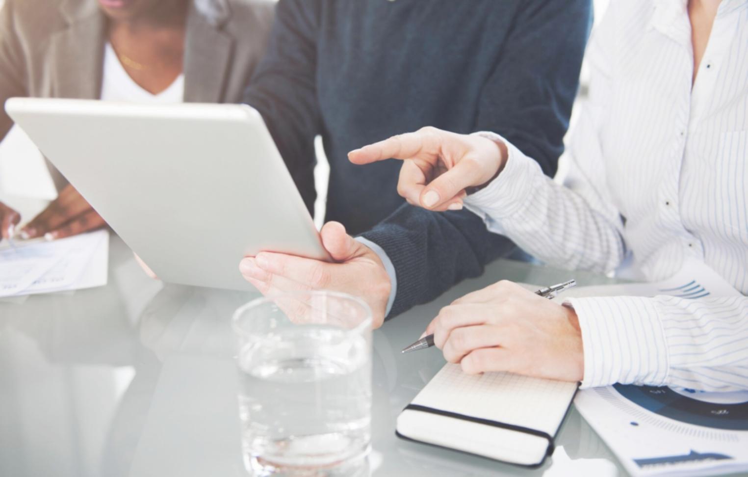 Financial professional analyzing business data and charts on computer screen